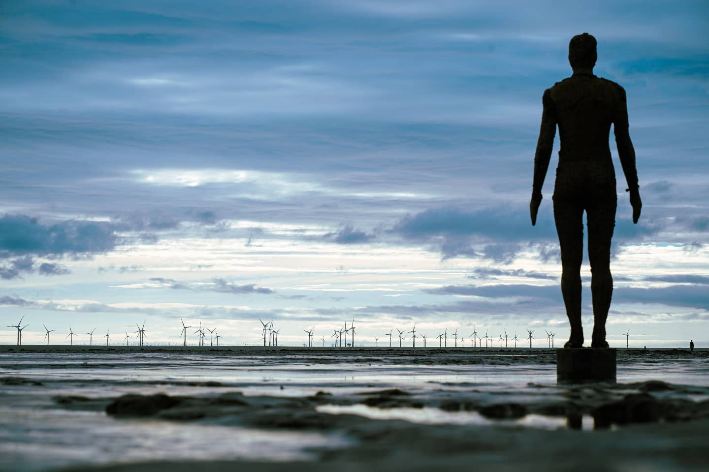 An Antony Gormley figure facing the sea at Crosby Beach, photographed by Harry Chapman